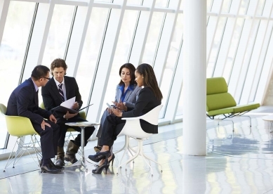 co workers talking in building lobby